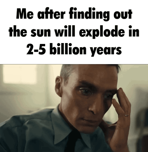 A Man In A Suit And Tie Holds His Hand To His Forehead In Front Of A Sign That Says Me GIF