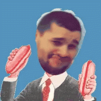 A Man In A Suit And Tie Holds Two Hot Dogs In His Hands GIF