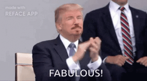 A Man In A Suit And Tie Is Applauding And Says Fabulous . GIF