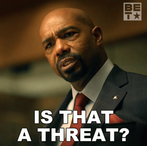 A Man In A Suit And Tie Is Asking If That Is A Threat GIF