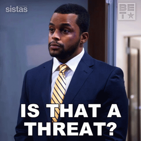 A Man In A Suit And Tie Is Asking If There Is A Threat GIF