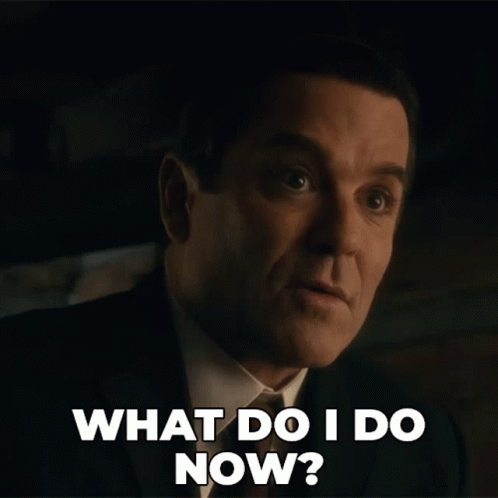 A Man In A Suit And Tie Is Asking What Do I Do Now GIF