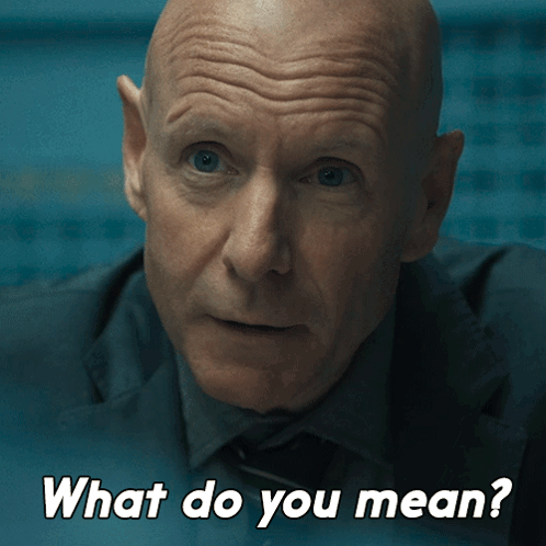 A Man In A Suit And Tie Is Asking What Do You Mean GIF