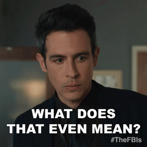 A Man In A Suit And Tie Is Asking " What Does That Even Mean " GIF