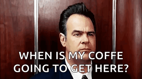 A Man In A Suit And Tie Is Asking When Is My Coffe Going To Get Here . GIF