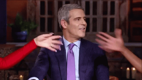 Man In Suit Hugged By Group Of People GIF