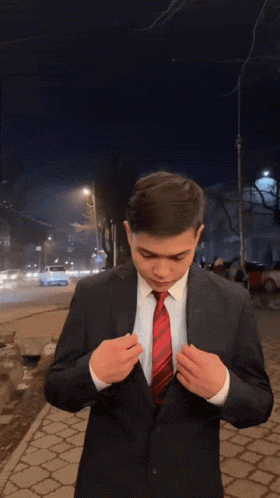 A Man In A Suit And Tie Is Blowing A Kiss At The Camera GIF