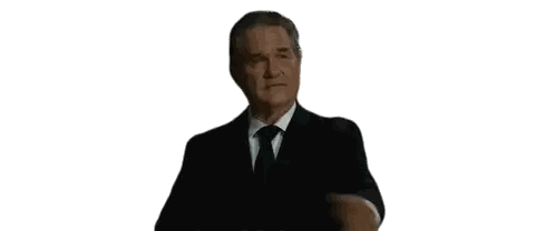 a man in a suit and tie is checking his watch