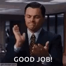 A Man In A Suit And Tie Is Clapping His Hands And Says `` Good Job '' . GIF