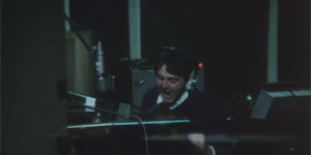 A Man In A Suit And Tie Is Covering His Ears With His Hands And The Word Argh Is Written Above Him GIF