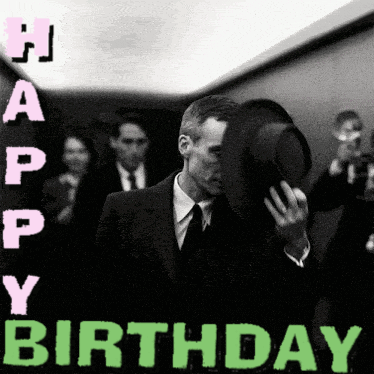 A Man In A Suit And Tie Is Covering His Face With His Hat And The Words Happy Birthday Are Above Him GIF