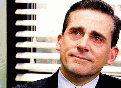 A Man In A Suit And Tie Is Crying In Front Of A Window With Blinds . GIF