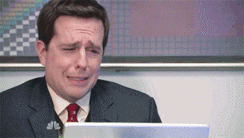 A Man In A Suit And Tie Is Crying While Sitting In Front Of A Laptop . GIF