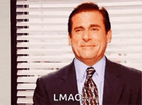 A Man In A Suit And Tie Is Crying While Standing In Front Of A Window With Blinds . GIF