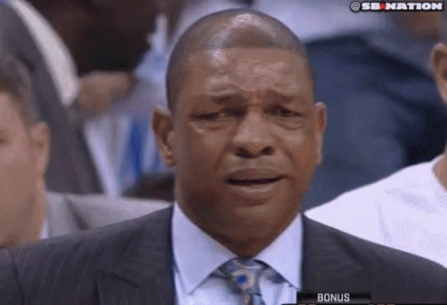A Man In A Suit And Tie Is Crying While Watching A Basketball Game GIF