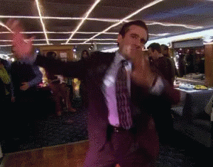 A Man In A Suit And Tie Is Dancing GIF