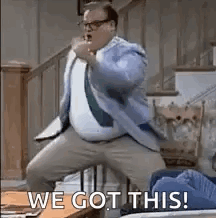 A Man In A Suit And Tie Is Dancing In A Living Room With The Words `` We Got This ! '' GIF