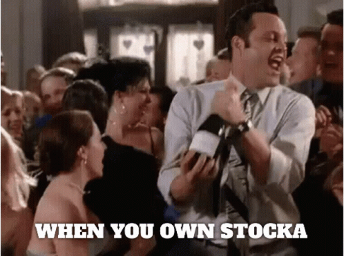 A Man In A Suit And Tie Is Dancing In Front Of A Crowd With The Words " When You Own Stocka " Written Below Him GIF
