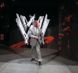 A Man In A Suit And Tie Is Dancing On A Stage In Front Of A W Logo GIF