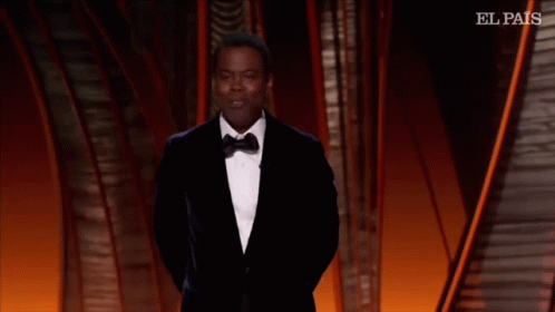 A Man In A Suit And Tie Is Dancing On A Stage With El Pais Written On The Bottom GIF