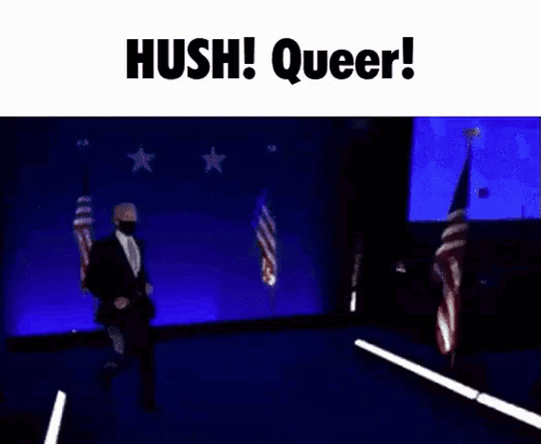 A Man In A Suit And Tie Is Dancing On A Stage With The Words Hush Queer Written Above Him . GIF