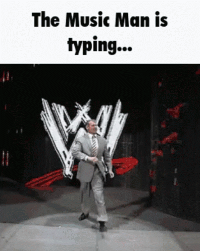A Man In A Suit And Tie Is Dancing On A Stage With The Words " The Music Man Is Typing " GIF