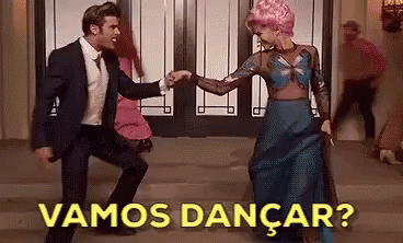 A Man In A Suit And Tie Is Dancing With A Woman In A Blue Dress With The Words Vamos Dancar Written Above Them GIF