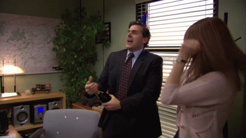 A Man In A Suit And Tie Is Dancing With A Woman In A Pink Shirt GIF