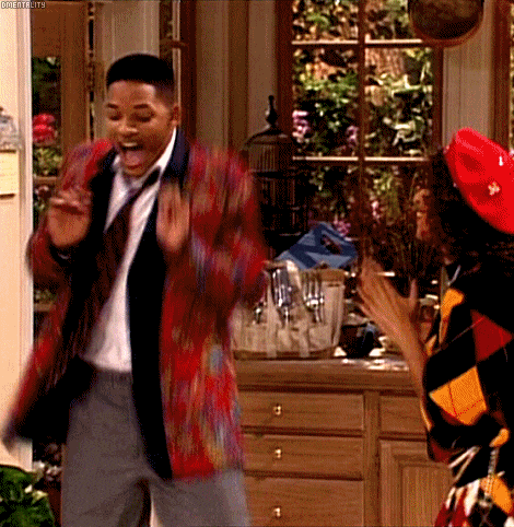A Man In A Suit And Tie Is Dancing With A Woman In A Red Hat GIF