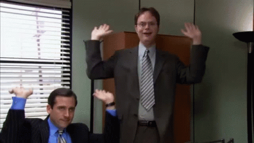 A Man In A Suit And Tie Is Dancing With Another Man GIF