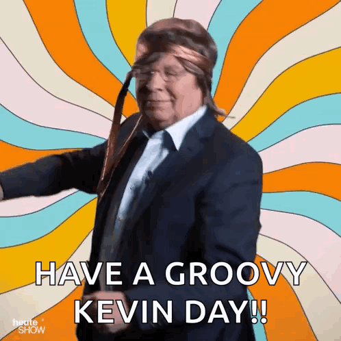 A Man In A Suit And Tie Is Dancing With The Words Have A Groovy Kevin Day Below Him GIF