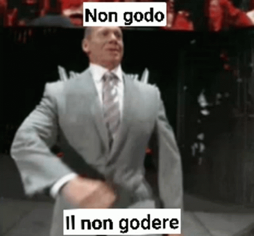 A Man In A Suit And Tie Is Dancing With The Words Non Godo Written Above Him GIF