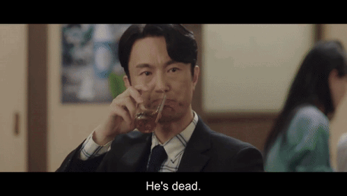 A Man In A Suit And Tie Is Drinking A Glass Of Whiskey And Says He 'S Dead . GIF
