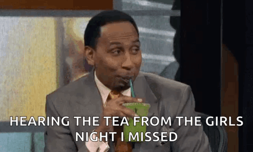 A Man In A Suit And Tie Is Drinking A Green Drink From A Plastic Cup . GIF