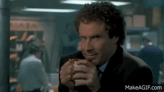 a man in a suit and tie is drinking from a cup