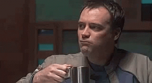 Man In Suit Drinking From Mug GIF