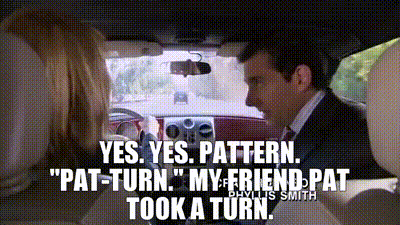 A Man In A Suit And Tie Is Driving A Car And Talking To A Woman . GIF