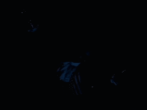 A Man In A Suit And Tie Is Floating In The Water GIF