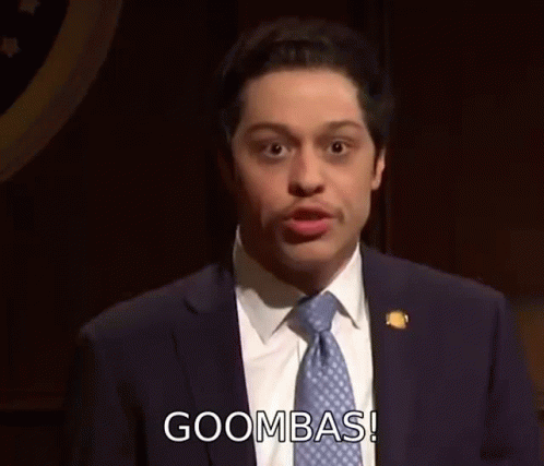 A Man In A Suit And Tie Is Giving A Speech . GIF