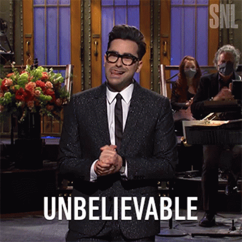 A Man In A Suit And Tie Is Giving A Speech And The Word Unbelievable Is On The Screen GIF