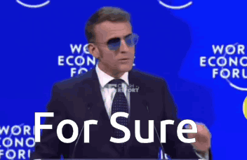 A Man In A Suit And Tie Is Giving A Speech And The Words For Sure Are On The Screen Behind Him GIF