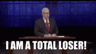A Man In A Suit And Tie Is Giving A Speech At A Podium And Saying `` I Am A Total Loser '' GIF