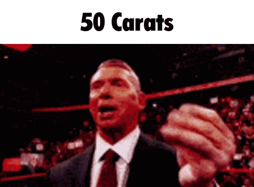 A Man In A Suit And Tie Is Giving A Speech With The Words 50 Carats Below Him GIF