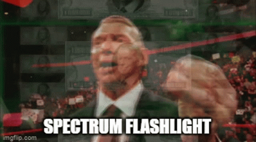 A Man In A Suit And Tie Is Giving A Speech With The Words Spectrum Flashlight Written Below Him GIF