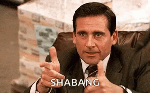 A Man In A Suit And Tie Is Giving A Thumbs Up And Pointing . GIF