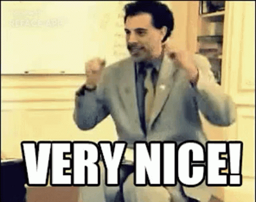 A Man In A Suit And Tie Is Giving A Thumbs Up And Saying `` Very Nice ! '' GIF