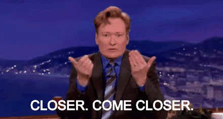 A Man In A Suit And Tie Is Giving A Thumbs Up And Says Closer Come Closer . GIF