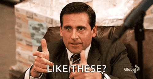 A Man In A Suit And Tie Is Giving A Thumbs Up And Says Like These . GIF