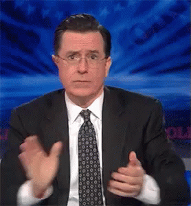 A Man In A Suit And Tie Is Giving A Thumbs Up Sign GIF