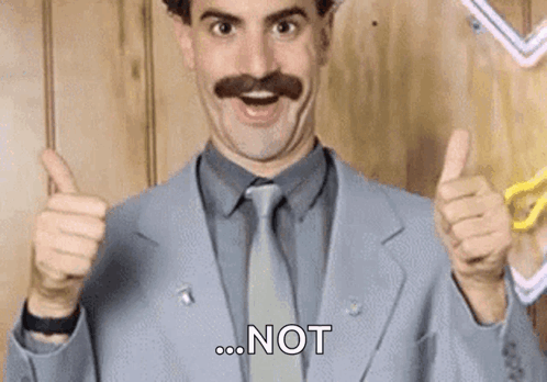 A Man In A Suit And Tie Is Giving A Thumbs Up Sign . GIF